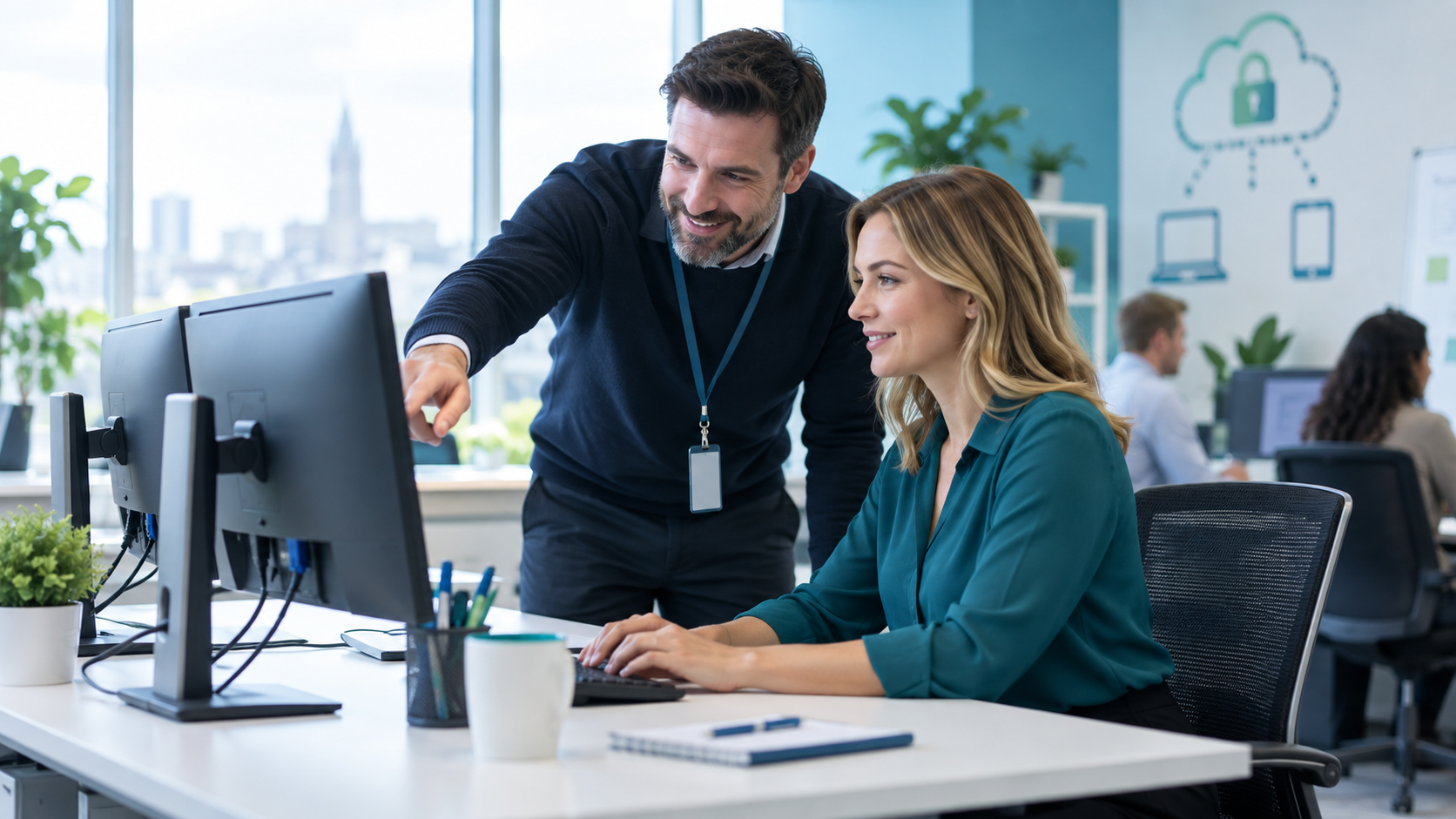 IT support professional helping a colleague in a modern office